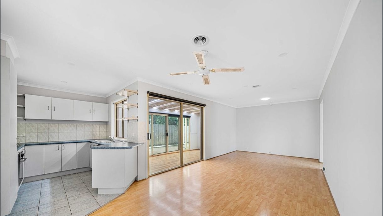 Open plan living and kitchen area with timber-look floors