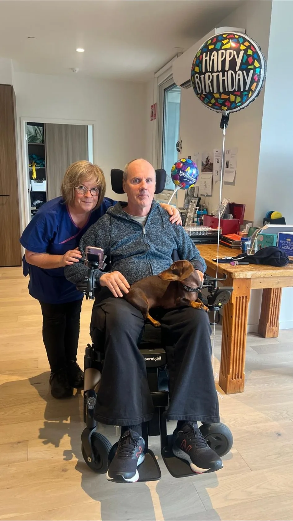A Resilient Life Care nurse at home with a participant, celebrating his birthday